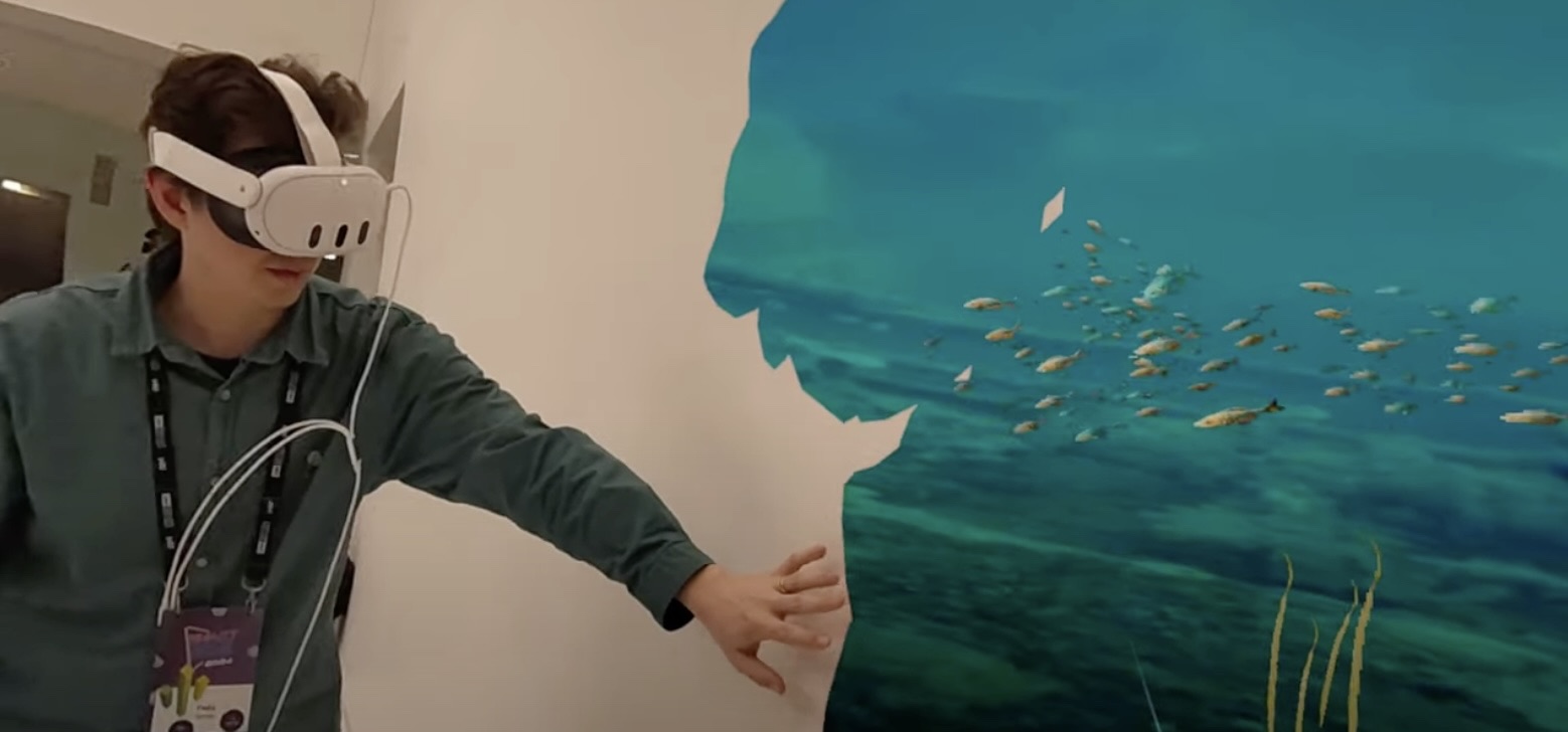 Man in headset engages with virtual underwater environment.