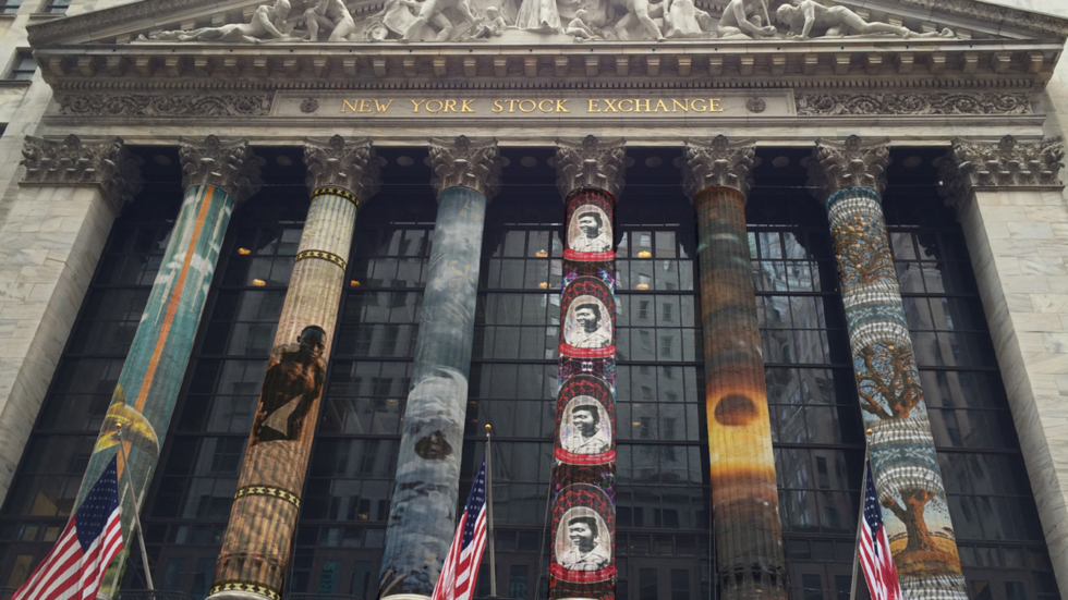 The columns of the New York Stock Exchange are overlayed with virtual weavings of African American history.