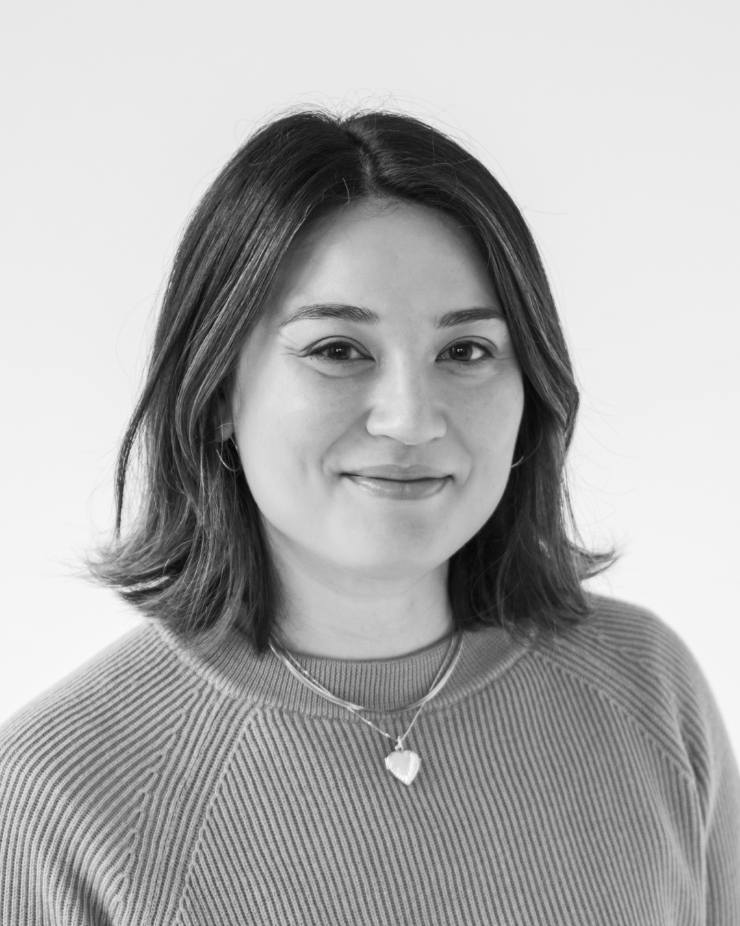 Woman with short brown hair smiles.