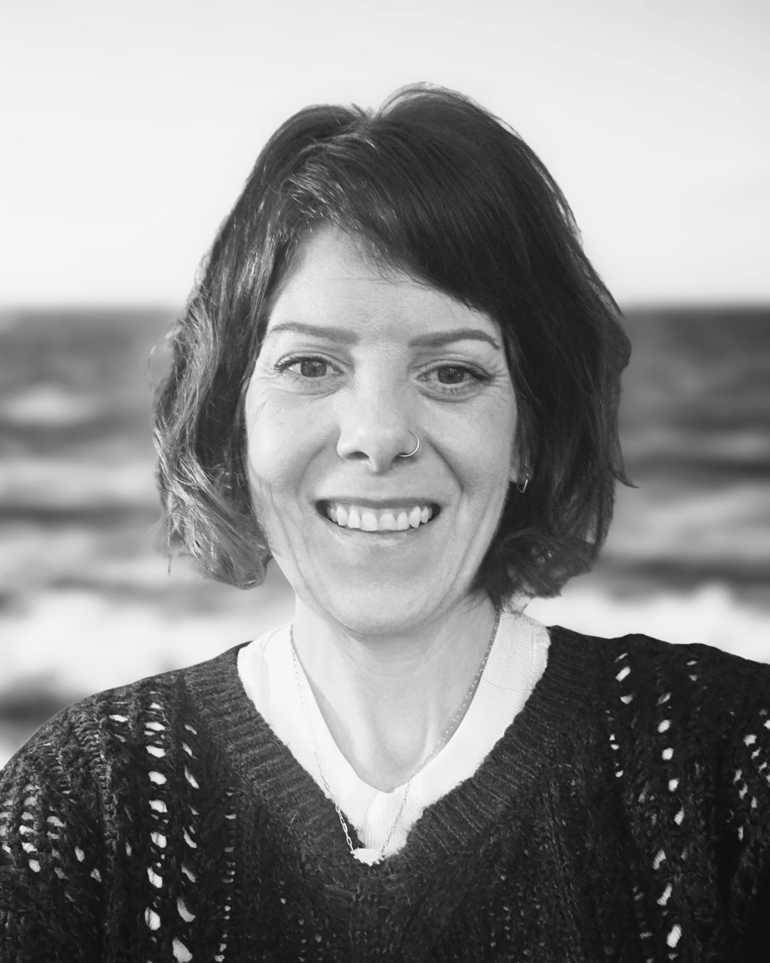 Selena smiles in front of the ocean