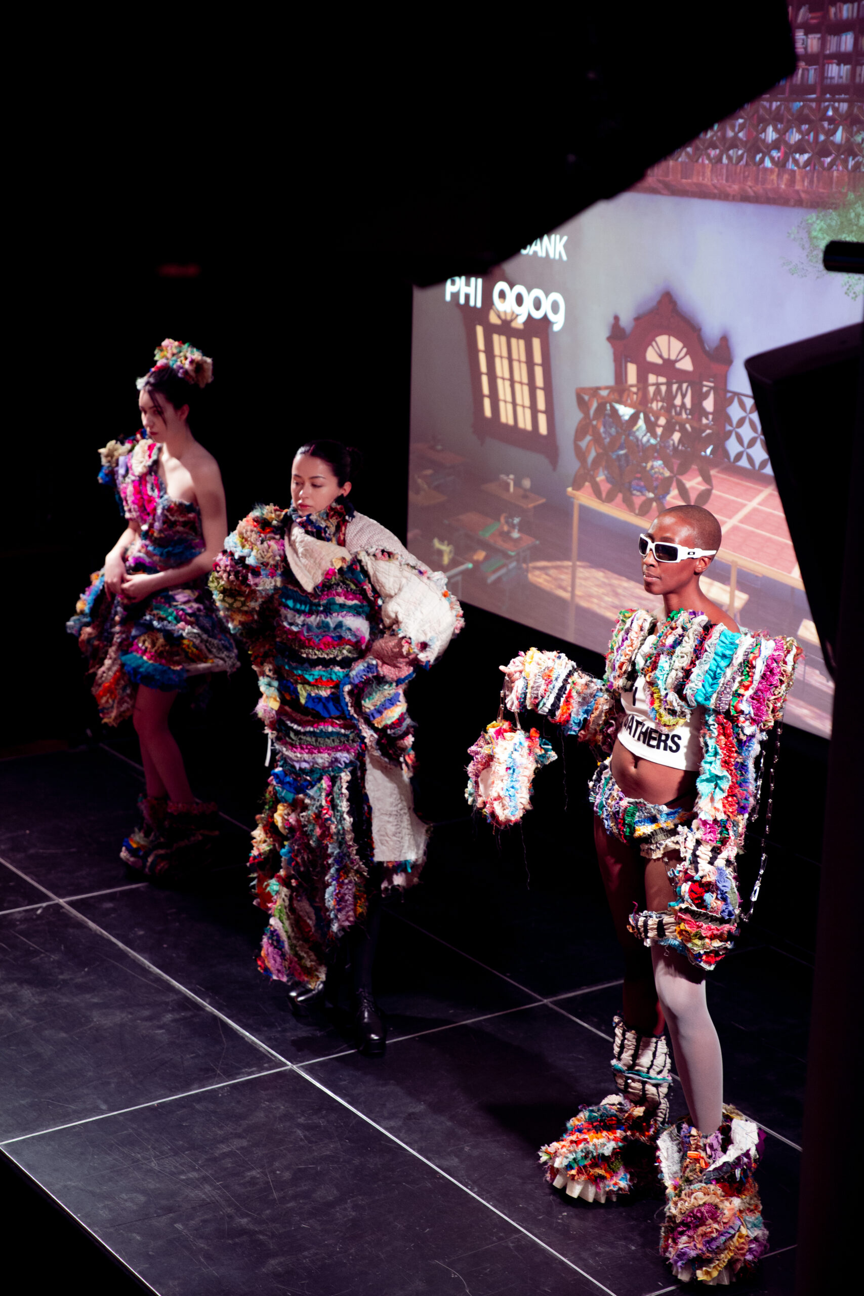 Three live models don ruffled fabric garments at the end-of-residency event for Gathered Cloths.