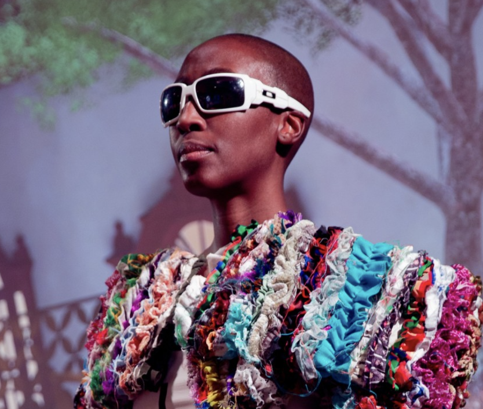 image of person wearing recycled clothing and sunglasses