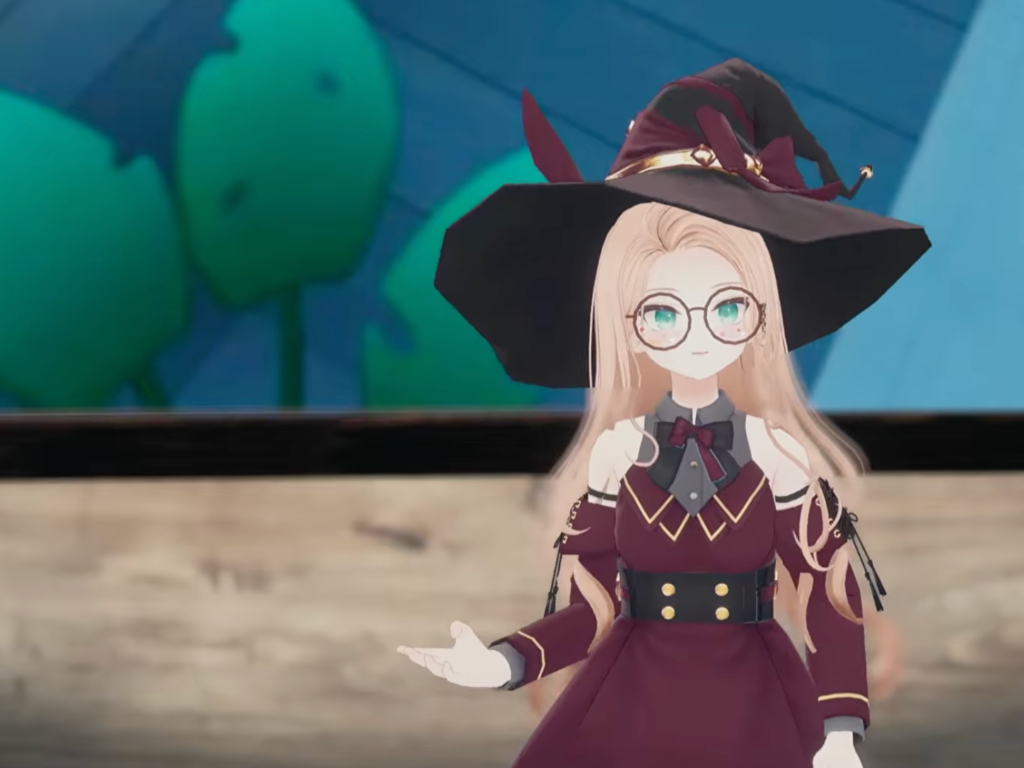 Tizzy's anime-style avatar with green eyes, blonde hair, glasses, and a witch's hat gestures to the audience.